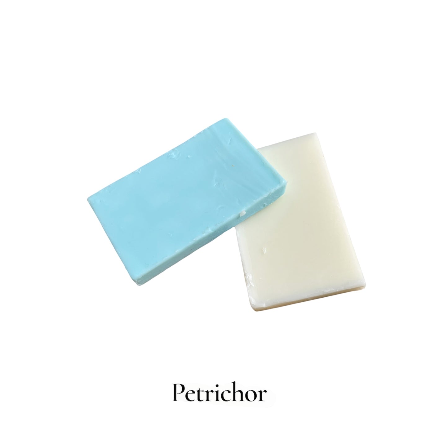 Two bars of soap, one blue and one white, on a white background with 'Petrichor' branding.
