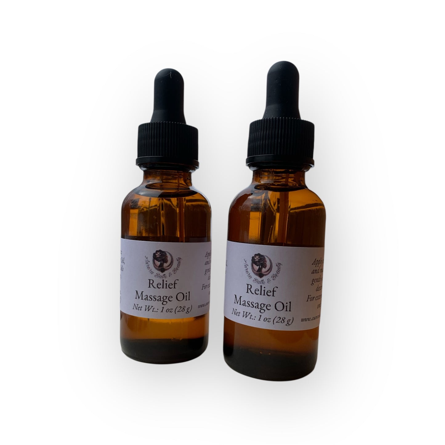 Two bottles of Relief Massage Oil with dropper caps on a white background