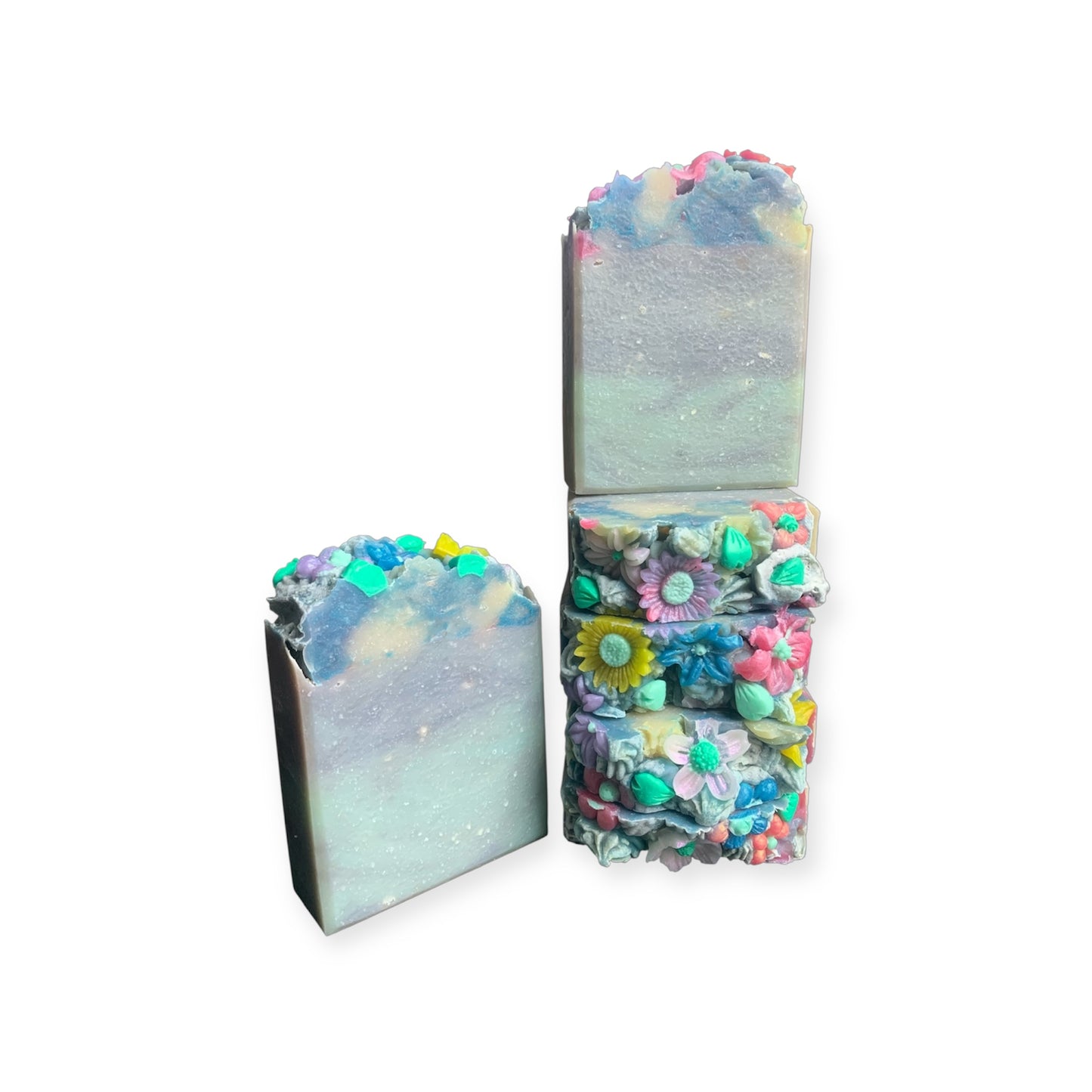 Blue soap bars with multicolor floral embeds on a white background