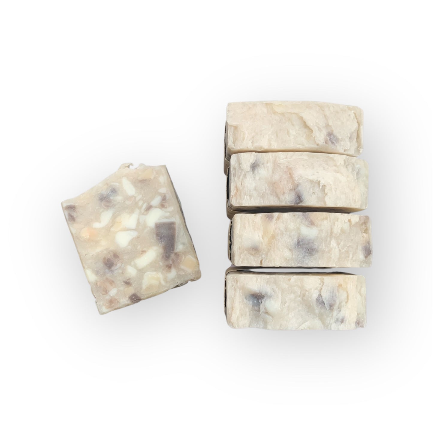 Five bars of soap with a marbled pattern on a white background