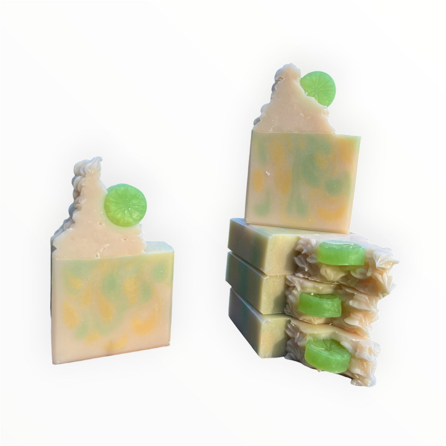 Stack of soap bars with green and yellow swirls on a white background