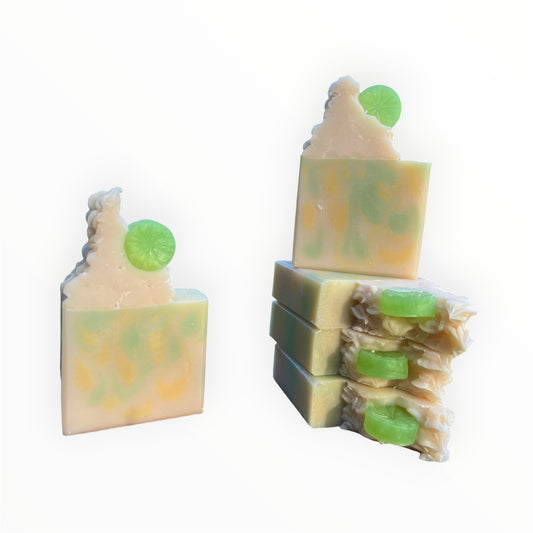 Stack of soap bars with green and yellow swirls on a white background