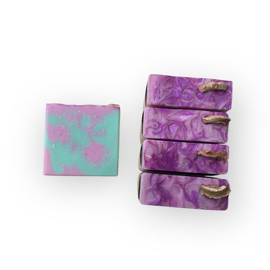 Set of purple and green marbled soap bars on a white background