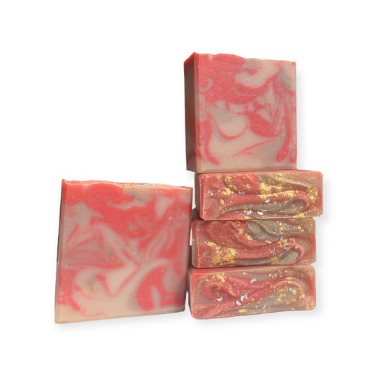 Stack of red,brown, and white marbled soap bars on a white background