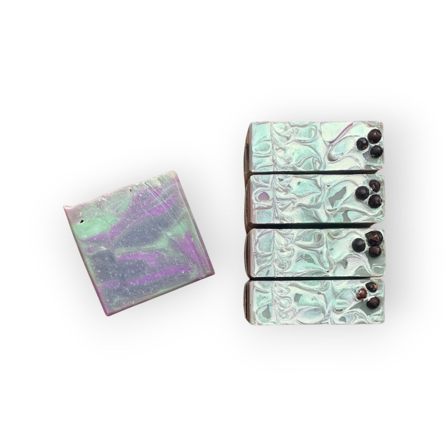 Set of marbled soap bars with a small square soap on a white background