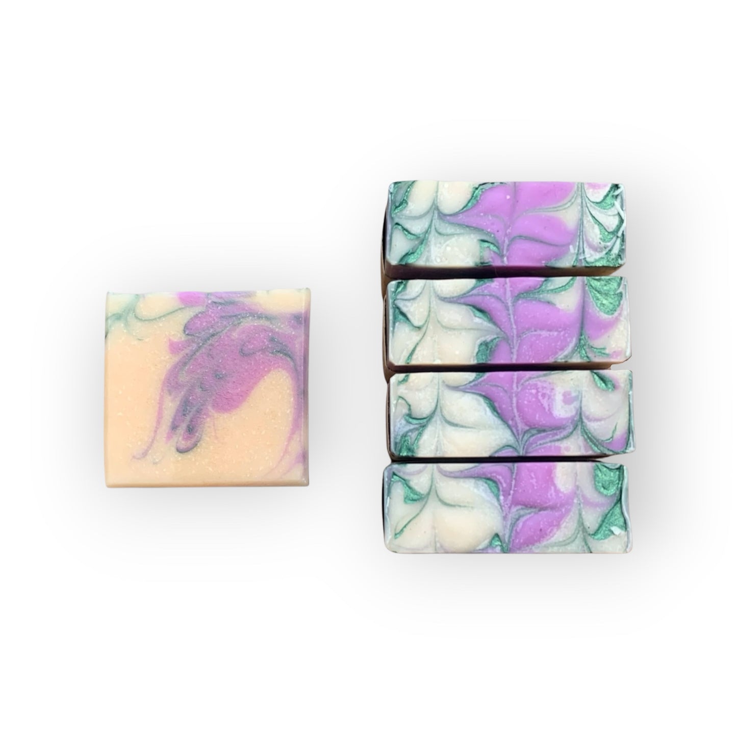 Set of marbled soap bars with purple and green patterns on a white background