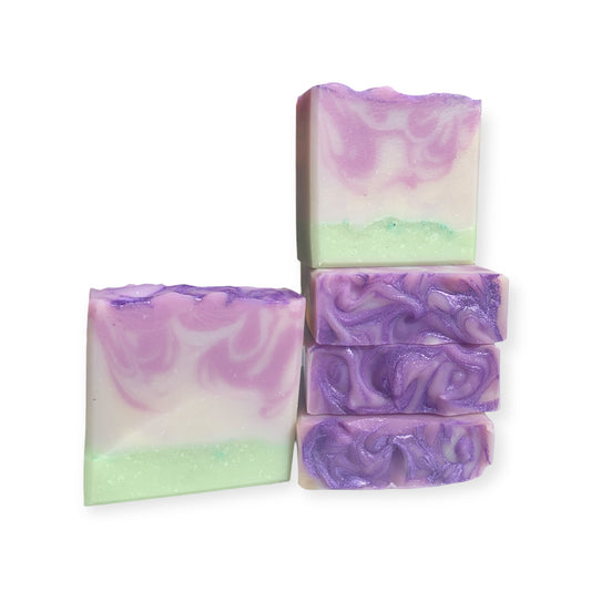 Swirled purple and green soap bars on a white background