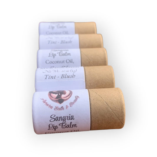 Five lip balm tubes with labels on a white background
