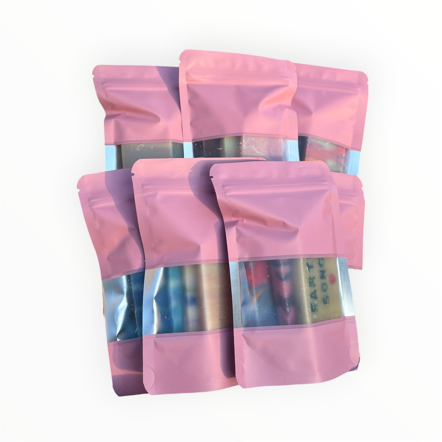 Pink pouches filled with a variety of artisan soap