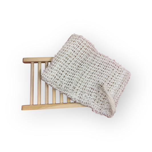 Sisal soap saver bag draped over wood ladder style soap dish