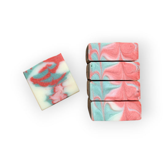 Marbled soap bars with red, green, and white patterns on a white background